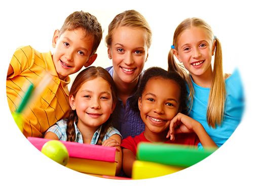 smiling teacher surrounded by smiling children